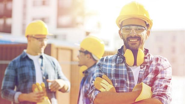 Construction worker with arms crossed smiling